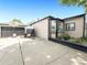 A well-kept home exterior with a driveway, garage, bay window, and manicured garden at 8820 Poze Blvd, Thornton, CO 80229