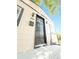 Charming exterior view of the home's front door and welcoming porch with black accents and a modern mailbox at 8820 Poze Blvd, Thornton, CO 80229