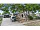 Inviting home featuring mature trees, a well-kept lawn, and a welcoming entrance at 8820 Poze Blvd, Thornton, CO 80229