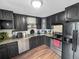 Well-equipped kitchen featuring stainless steel appliances, granite countertops, and dark cabinetry at 8820 Poze Blvd, Thornton, CO 80229