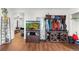 Bright living room features wood floors, aquarium, storage shelving, and a comfortable seating area, blending functionality at 8820 Poze Blvd, Thornton, CO 80229
