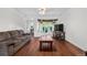 Bright living room with a large bay window, wood floors, and a comfortable couch at 8820 Poze Blvd, Thornton, CO 80229