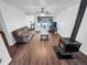 Cozy living room with a decorative fireplace, hardwood floors, and a large window with plants at 8820 Poze Blvd, Thornton, CO 80229