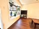 Bright living room with window seat, wooden floors, and plants for decor at 8820 Poze Blvd, Thornton, CO 80229