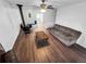 Open living room featuring a wood-burning stove, ceiling fan, and access to the balcony at 8820 Poze Blvd, Thornton, CO 80229