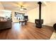 Inviting living room features wood-look floors, a cozy wood-burning stove, and a comfortable seating area at 8820 Poze Blvd, Thornton, CO 80229