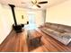 Spacious living room features wood-look floors, a cozy couch, wood-burning stove, and access to an outdoor balcony at 8820 Poze Blvd, Thornton, CO 80229