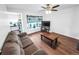 Spacious living room with a large window, hardwood floors, and comfortable seating at 8820 Poze Blvd, Thornton, CO 80229