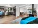 Open-concept living space with wood flooring seamlessly connects the kitchen and living area at 8820 Poze Blvd, Thornton, CO 80229