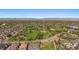 Wide aerial view of a lush community park with a city skyline backdrop at 2461 Spruce St, Denver, CO 80238