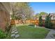 Well-maintained backyard with artificial turf, stone pavers, and a privacy fence at 2461 Spruce St, Denver, CO 80238