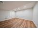 Open basement space with hardwood flooring, recessed lighting, and a bright, clean aesthetic at 2461 Spruce St, Denver, CO 80238