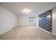 Finished basement with plush carpet, a window for natural light, and stylish accent wall at 2461 Spruce St, Denver, CO 80238