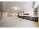 Finished basement features a modern fireplace, built-in cabinetry, and neutral carpeting for a cozy, inviting space at 2461 Spruce St, Denver, CO 80238