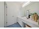 Bright bathroom featuring double sinks, white cabinets, mosaic tile flooring, and a large mirror at 2461 Spruce St, Denver, CO 80238
