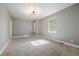 Spacious bedroom features neutral walls, wall-to-wall carpet, and bright windows at 2461 Spruce St, Denver, CO 80238