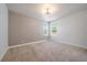 Empty bedroom featuring neutral walls, wall-to-wall carpet, and bright windows at 2461 Spruce St, Denver, CO 80238