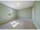 Bright bedroom featuring green walls, wall-to-wall carpet, and one bright window at 2461 Spruce St, Denver, CO 80238