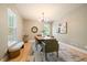 Stylish dining room featuring modern lighting, hardwood floors, and ample natural light at 2461 Spruce St, Denver, CO 80238