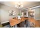 Dining room with a contemporary chandelier, hardwood floors, and views to the office at 2461 Spruce St, Denver, CO 80238