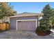 A large garage with a gray door, well-lit exterior, and a manicured lawn at 2461 Spruce St, Denver, CO 80238