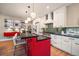 Bright kitchen with modern white cabinets, mosaic backsplash, and a vibrant red island at 2461 Spruce St, Denver, CO 80238