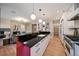 Open kitchen featuring a red island with black countertops and modern white cabinets and stainless appliances at 2461 Spruce St, Denver, CO 80238