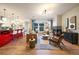 Cozy living room with a fireplace, large windows, and open access to the kitchen at 2461 Spruce St, Denver, CO 80238