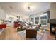 Open-concept living room featuring a fireplace, modern lighting, and seamless kitchen access at 2461 Spruce St, Denver, CO 80238