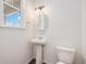 A half bathroom with a pedestal sink at 10506 Akron St, Commerce City, CO 80640