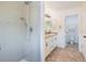 Bathroom featuring a glass enclosed shower and a vanity with double sinks at 10506 Akron St, Commerce City, CO 80640