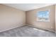 Carpeted bedroom with a window offering neighborhood views at 10506 Akron St, Commerce City, CO 80640