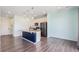 Modern kitchen features stainless appliances, a stylish island, and hardwood floors at 10506 Akron St, Commerce City, CO 80640