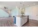 Kitchen island with sink, adjacent to living room with carpet at 10506 Akron St, Commerce City, CO 80640
