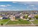 Aerial view of a neighborhood featuring well-manicured lawns and fenced yards with recreational equipment at 11343 E 163Rd Ct, Brighton, CO 80602