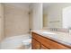 Bathroom featuring a tile shower and tub, a sink with granite top and a wood cabinet at 11343 E 163Rd Ct, Brighton, CO 80602