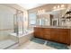 Primary bathroom featuring double vanity, soaking tub, glass shower, and bright window at 11343 E 163Rd Ct, Brighton, CO 80602