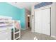 Bedroom featuring light blue accent wall, name decoration, and large closet sliding doors at 11343 E 163Rd Ct, Brighton, CO 80602