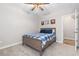 Light-filled bedroom featuring a ceiling fan, wood frame bed, and views to the exterior at 11343 E 163Rd Ct, Brighton, CO 80602