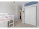 Comfortable bedroom with gray walls, carpeting, closet space, and a peek into the nearby bathroom at 11343 E 163Rd Ct, Brighton, CO 80602