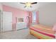 Bedroom with a light pink wall, plush carpet, a white bed, and a matching dresser at 11343 E 163Rd Ct, Brighton, CO 80602
