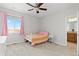 Bright bedroom with carpet, small bed, and pink curtains by the window at 11343 E 163Rd Ct, Brighton, CO 80602