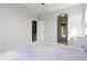 Bedroom with door to the hallway and the bathroom, furnished with purple bedspread at 11343 E 163Rd Ct, Brighton, CO 80602