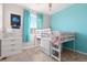 Bedroom featuring a blue accent wall, NASA decor, a white loft bed, and blue curtains at 11343 E 163Rd Ct, Brighton, CO 80602