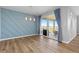 Dining area with sliding glass doors leading to outdoor space and featuring stylish blue accent wall at 11343 E 163Rd Ct, Brighton, CO 80602