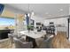 Open concept dining area, featuring a large table, modern lighting, and seamless connection to the kitchen at 11343 E 163Rd Ct, Brighton, CO 80602