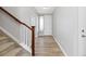Bright entryway with hardwood floors, staircase, white walls, and a front door at 11343 E 163Rd Ct, Brighton, CO 80602