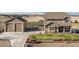 Charming two-story home with a landscaped front yard, stone accents, and a detached two-car garage at 11343 E 163Rd Ct, Brighton, CO 80602