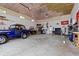 Spacious garage featuring high ceilings, ample storage, and a blue Jeep at 11343 E 163Rd Ct, Brighton, CO 80602