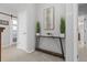 Hallway view with console table and decor, neutral walls and carpet with a white door and barn door at 11343 E 163Rd Ct, Brighton, CO 80602